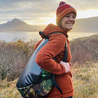 Woman wearing Swim Feral Terrapin bag with landscape in the distance
